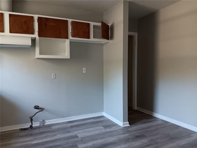 washroom with dark hardwood / wood-style floors and a textured ceiling