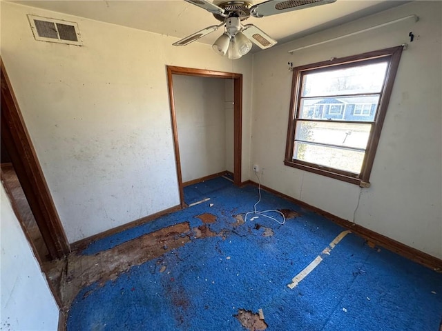 unfurnished bedroom with a closet, visible vents, a ceiling fan, and baseboards