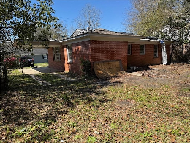 view of side of home with brick siding