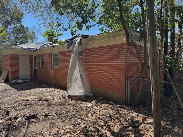 view of home's exterior featuring brick siding