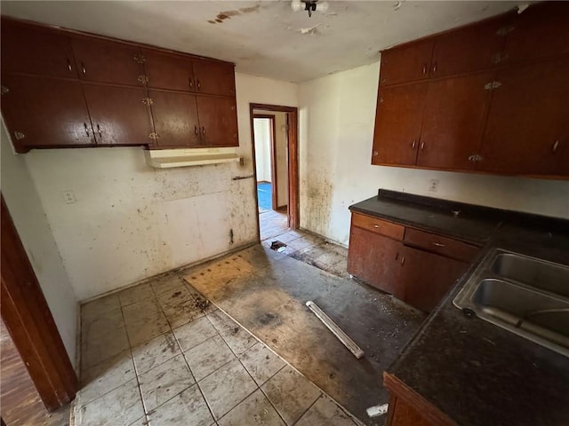 kitchen with a sink and dark countertops