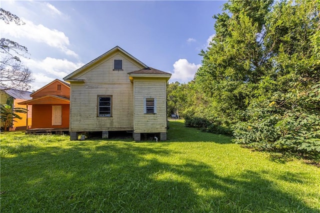 back of property featuring a yard