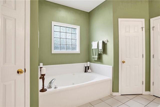 bathroom with a garden tub and tile patterned flooring