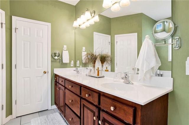 full bathroom with double vanity, a sink, and tile patterned floors