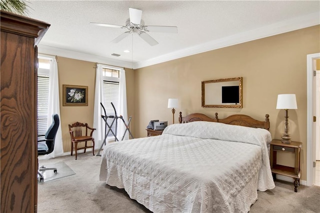 carpeted bedroom with crown molding, baseboards, visible vents, and ceiling fan
