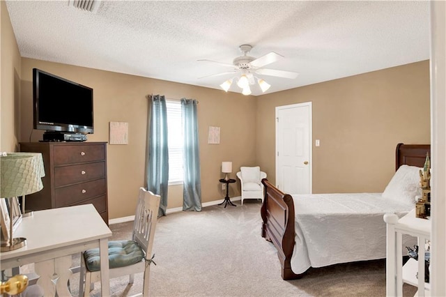 carpeted bedroom with baseboards, a ceiling fan, a textured ceiling, and visible vents