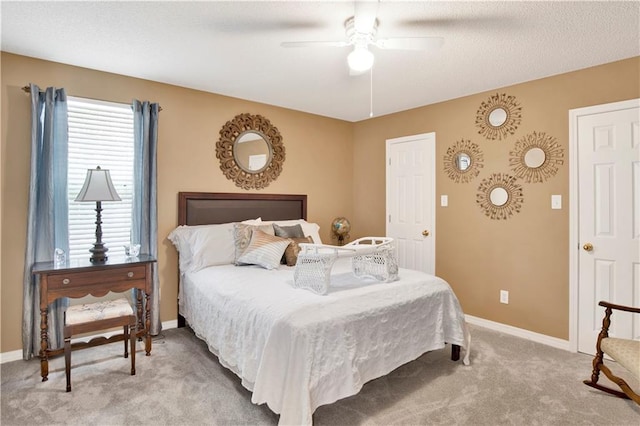 bedroom featuring baseboards, ceiling fan, and light carpet