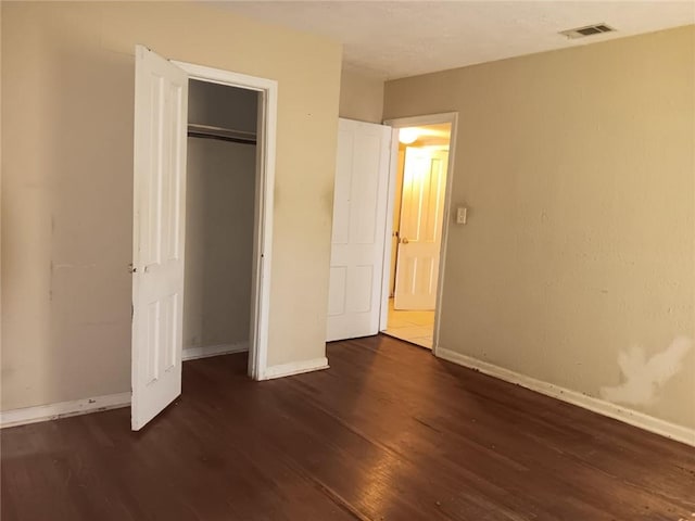 1863 Mott Dr N, Mobile, AL 36617 - unfurnished bedroom featuring wood finished floors, baseboards, and a closet