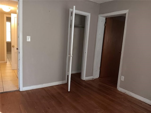 1863 Mott Dr N, Mobile, AL 36617 - unfurnished bedroom featuring baseboards, wood finished floors, and a closet