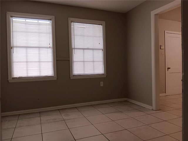 1863 Mott Dr N, Mobile, AL 36617 - unfurnished room with light tile patterned flooring, baseboards, and healthy amount of natural light