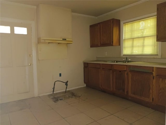 1863 Mott Dr N, Mobile, AL 36617 - kitchen with crown molding, light countertops, brown cabinetry, a sink, and baseboards
