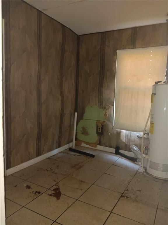 1863 Mott Dr N, Mobile, AL 36617 - tiled spare room with water heater and wooden walls