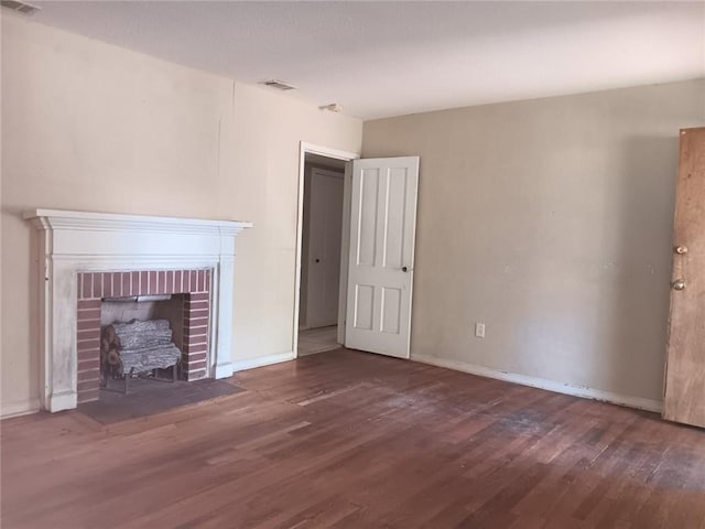1863 Mott Dr N, Mobile, AL 36617 - unfurnished living room featuring wood finished floors, a fireplace, and baseboards