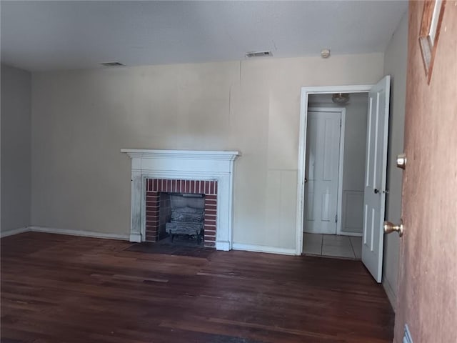 1863 Mott Dr N, Mobile, AL 36617 - unfurnished living room with wood finished floors, baseboards, and a fireplace