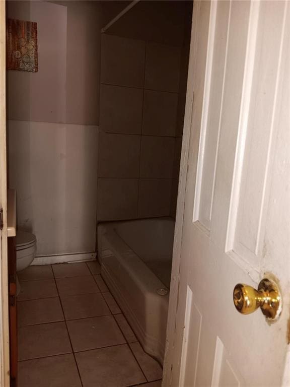 1863 Mott Dr N, Mobile, AL 36617 - bathroom featuring toilet, tile patterned flooring, and washtub / shower combination