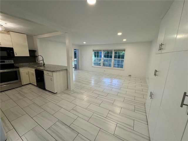 kitchen featuring decorative backsplash, white cabinets, black appliances, stone countertops, and sink