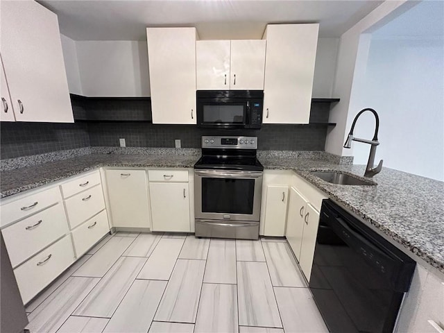 kitchen featuring sink, black appliances, stone countertops, and decorative backsplash