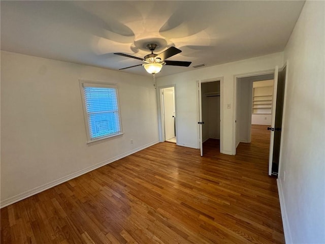 unfurnished bedroom with ceiling fan and hardwood / wood-style floors