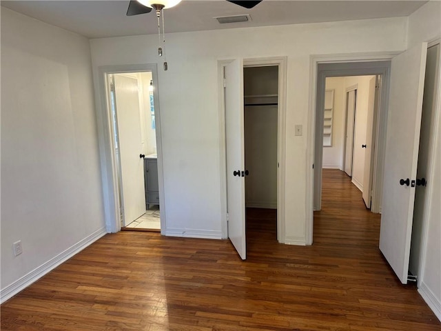 unfurnished bedroom featuring dark hardwood / wood-style floors and ceiling fan