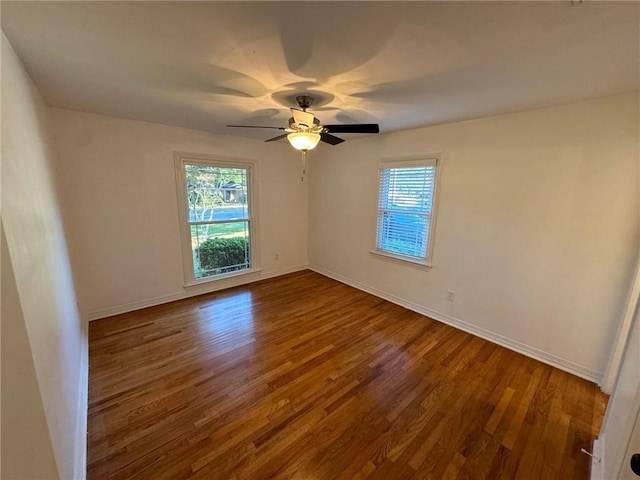 spare room with ceiling fan, hardwood / wood-style flooring, and plenty of natural light