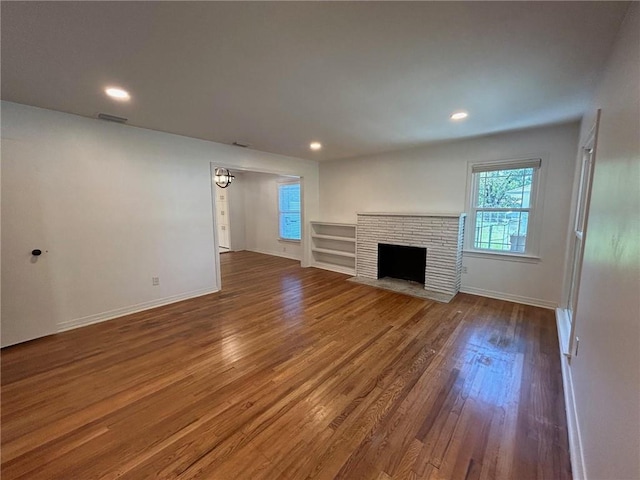 unfurnished living room featuring hardwood / wood-style flooring and a fireplace