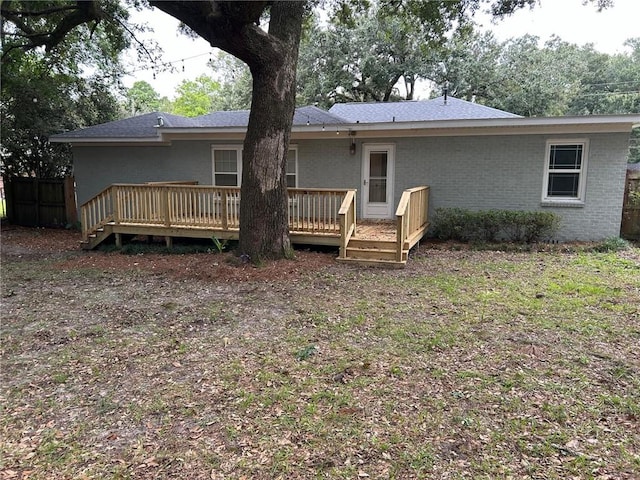 back of house featuring a wooden deck