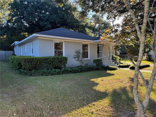 ranch-style house with a front lawn