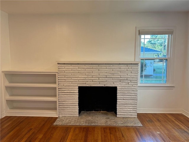 details with wood-type flooring and a brick fireplace