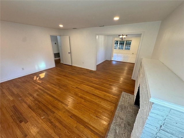 unfurnished living room with wood-type flooring