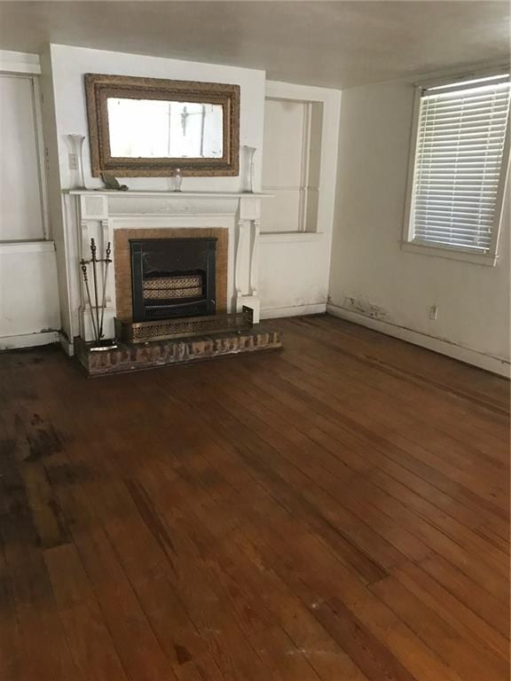 unfurnished living room featuring dark hardwood / wood-style flooring