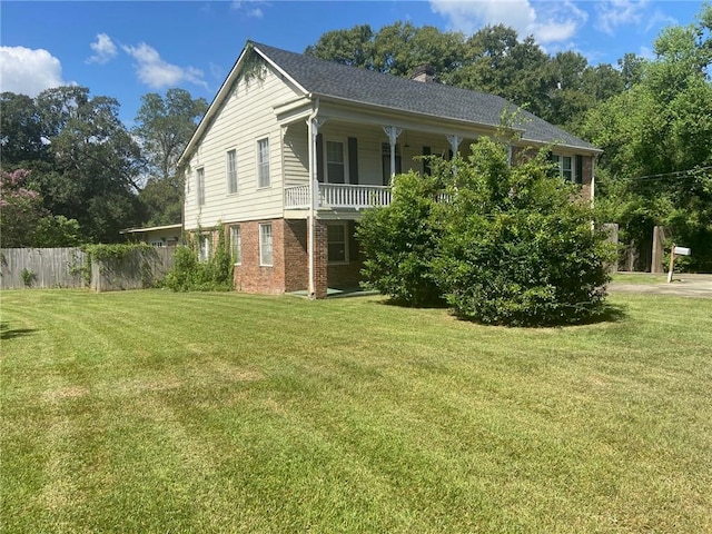 view of home's exterior featuring a yard and covered porch