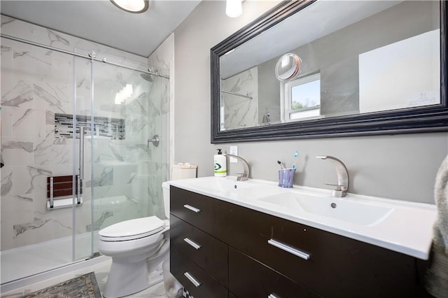 bathroom with vanity, an enclosed shower, and toilet