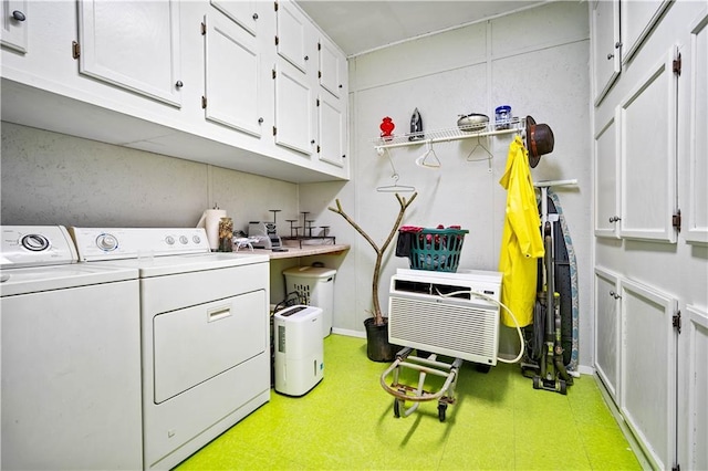 laundry room with washer and clothes dryer and cabinets