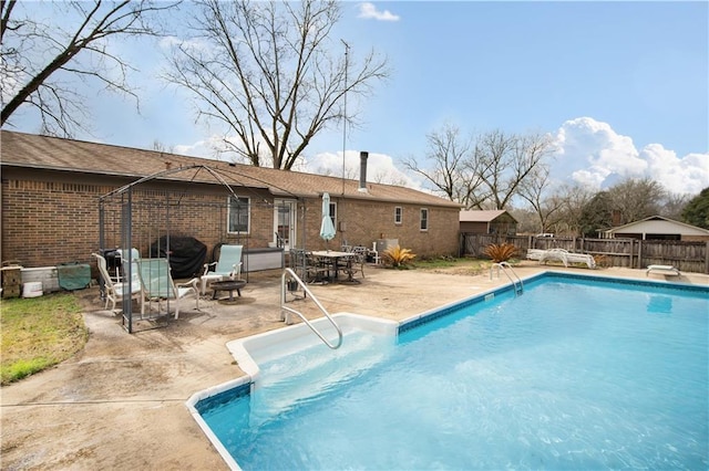 view of pool featuring a patio area and an outdoor fire pit