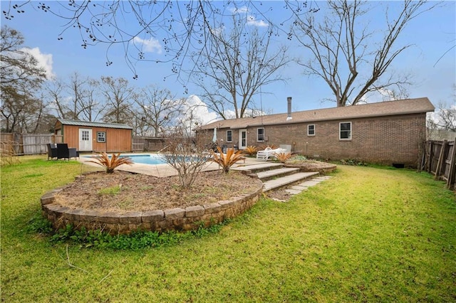 rear view of property with a storage shed, a yard, and a fenced in pool