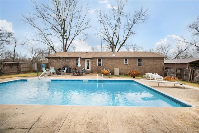 view of pool featuring cooling unit and a patio