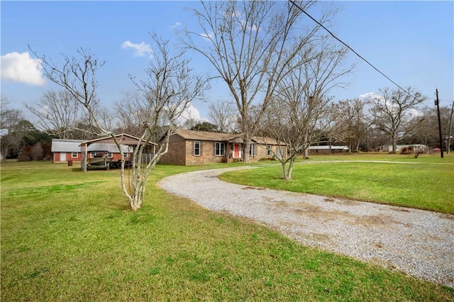 view of front of home with a carport and a front yard