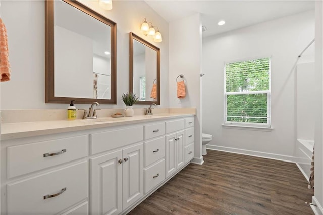 911 Lockenbie Pl, Dauphin Island, AL 36528 - full bathroom featuring double vanity, wood finished floors,  shower combination, and recessed lighting
