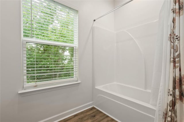 911 Lockenbie Pl, Dauphin Island, AL 36528 - full bath with shower / bath combo and wood finished floors