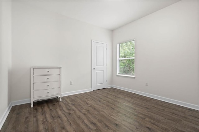 911 Lockenbie Pl, Dauphin Island, AL 36528 - unfurnished bedroom featuring dark wood-style flooring and baseboards
