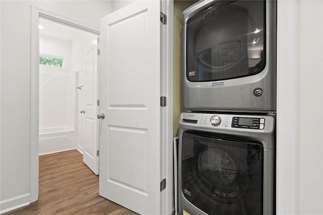 911 Lockenbie Pl, Dauphin Island, AL 36528 - washroom with stacked washing machine and dryer and wood finished floors