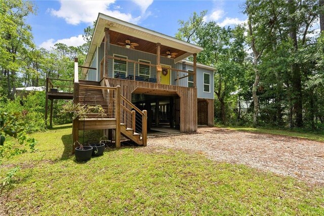 911 Lockenbie Pl, Dauphin Island, AL 36528 - back of property with a ceiling fan, a yard, and stairs