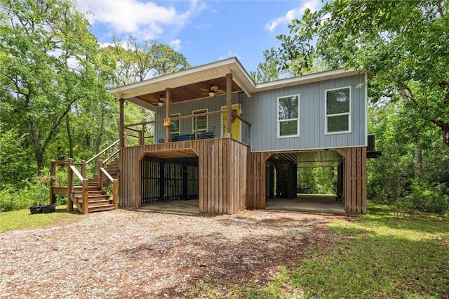 911 Lockenbie Pl, Dauphin Island, AL 36528 - view of front of home with a ceiling fan, a carport, stairway, driveway, and a wooden deck