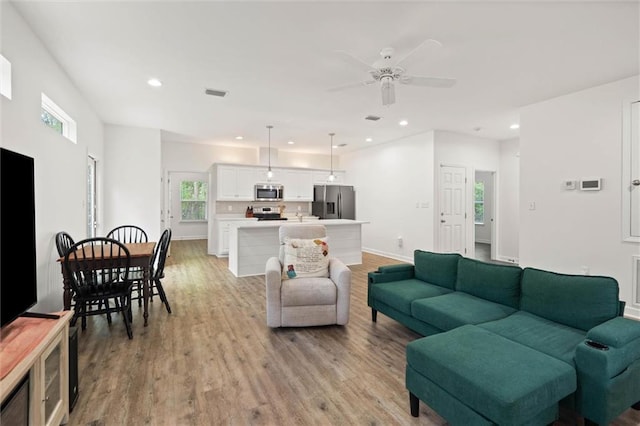 911 Lockenbie Pl, Dauphin Island, AL 36528 - living room featuring plenty of natural light, a ceiling fan, light wood finished floors, and recessed lighting