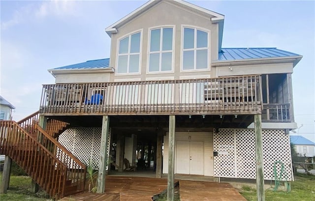 rear view of house featuring a deck