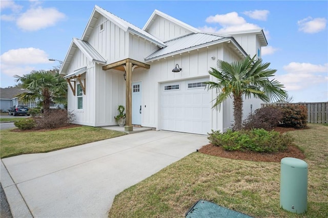 modern farmhouse style home featuring board and batten siding, concrete driveway, a front yard, an attached garage, and metal roof