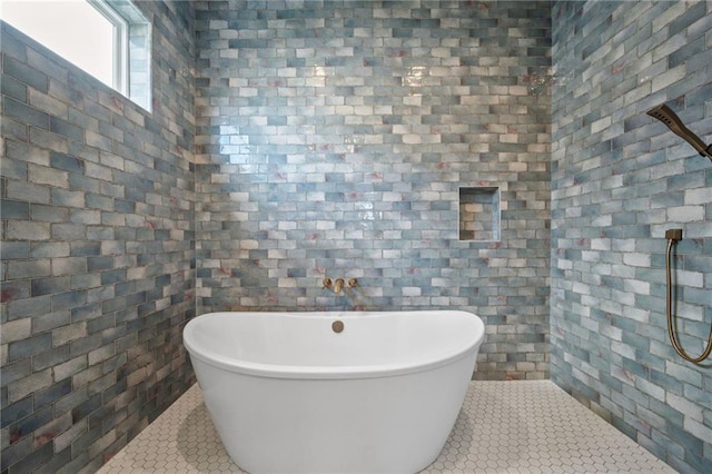 full bathroom with tile patterned floors and a soaking tub