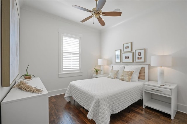 bedroom with ceiling fan, wood finished floors, baseboards, and ornamental molding