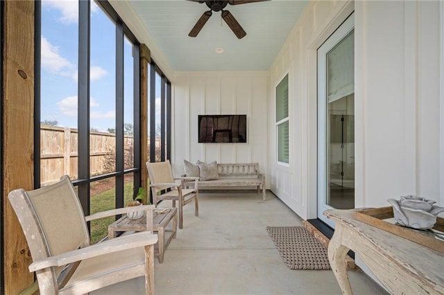 sunroom / solarium with a ceiling fan