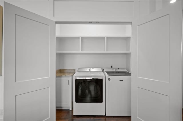 washroom with dark wood finished floors and separate washer and dryer